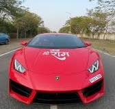 मृदुल तिवारी  with his red Lamborghini Huracán car collection.
